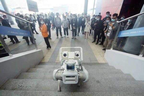 People watch a robotic dog at the Apsara Conference, a cloud computing and artificial intelligence (AI) conference in Hangzhou, in China's eastern Zhejiang Province, on Nov. 3, 2022. (STR/AFP via Getty Images)