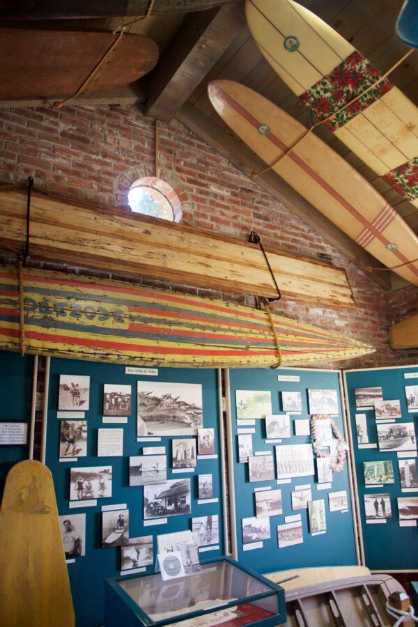 A wall of photographs and surfboards inside the Santa Cruz Surfing Museum. (Courtesy of Karen Gough)