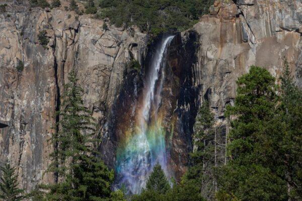 A rainbow shines through the mist at Bridalveil Fall in Yosemite National Park, Calif., on July 6, 2020. (Apu Gomes/AFP via Getty Images)