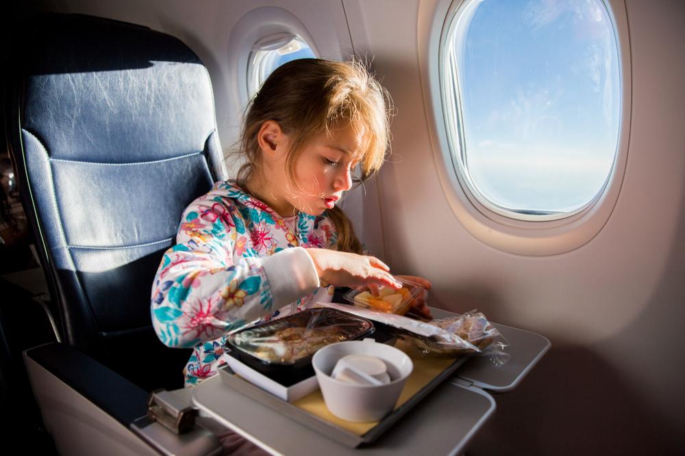 Dress the kids in comfortable clothes and bring snacks to make long flights go smoothly. (Aleksandra Suzi/Shutterstock)