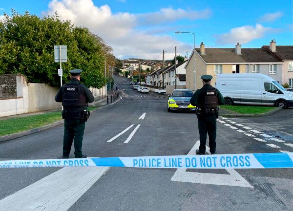 Officers from the Police Service of Northern Ireland (PSNI) stand guard at the scene, following the attempted murder of two officers in Strabane, Northern Ireland, on Nov. 18, 2022. (David Young/PA via AP)