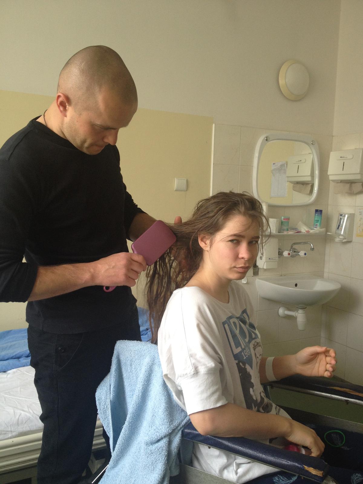 Kamil brushing Kasia's hair at a hospital in Warsaw, Poland. (Courtesy of <a href="https://www.instagram.com/equestriankasiabukowska/">Kasia Bukowska</a>)