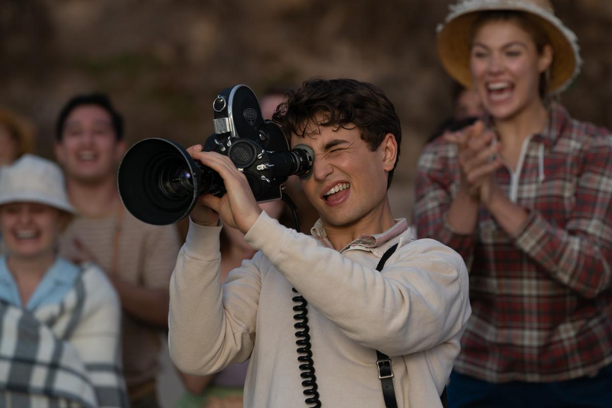 High school filmmaking enthusiast Sammy Fabelman (Gabriel LaBelle) shooting footage at the traditional high school beach outing, in "The Fabelmans." (Merie Weismiller Wallace/Universal Pictures)