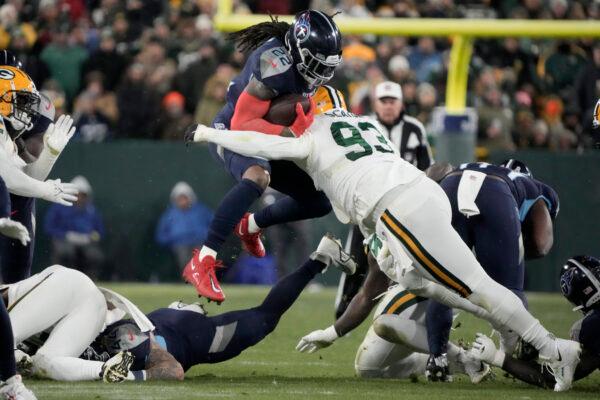 Tennessee Titans running back Derrick Henry (22) is stopped as he runs the ball by Green Bay Packers defensive tackle T.J. Slaton (93) during the first half of an NFL football game in Green Bay, Wis., on Nov. 17, 2022. (Morry Gash/AP Photo)