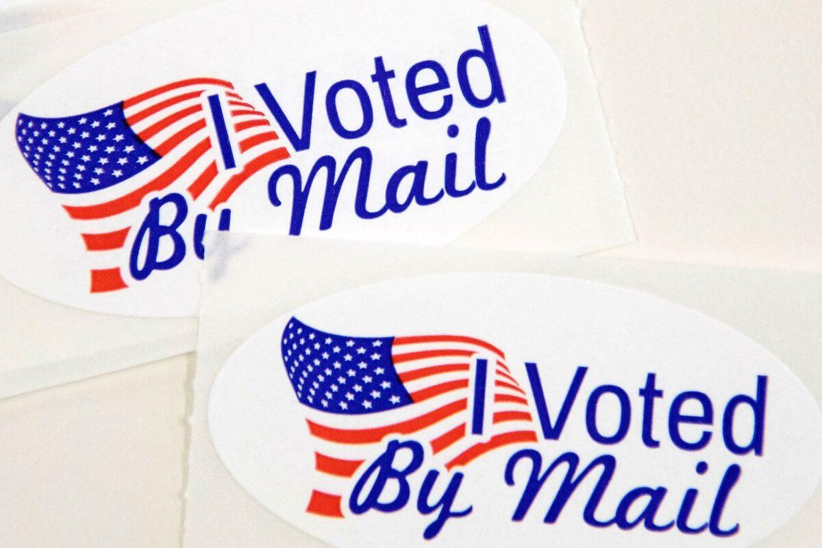 Stickers that read "I Voted By Mail" sit on a table waiting to be stuffed into envelopes by absentee ballot election workers at the Mecklenburg County Board of Elections office in Charlotte, N.C. on Sept. 4, 2020. (Logan Cyrus/AFP via Getty Images)