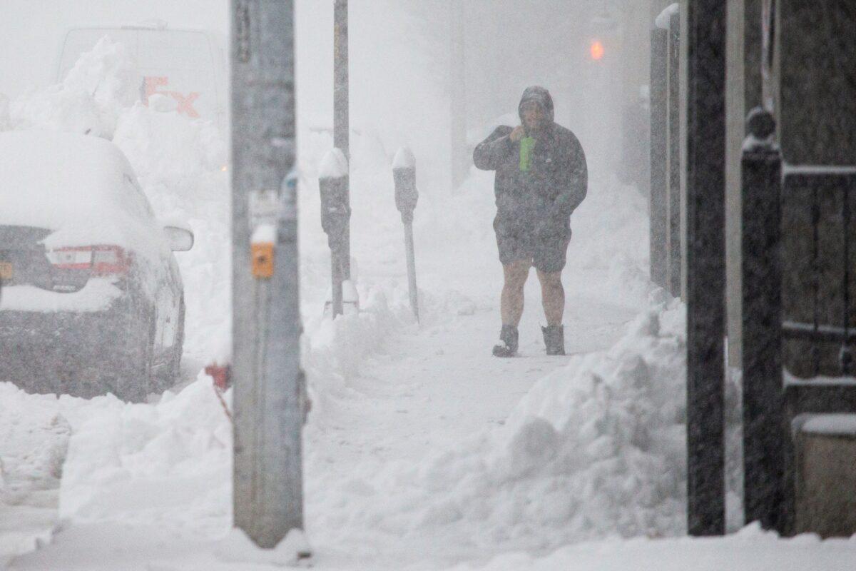 A person walks through downtown in the snow in Buffalo, N.Y., on Nov. 18, 2022. (Joshua Bessex/AP Photo)