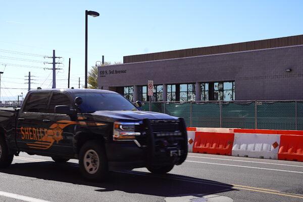 A Maricopa County Sheriff's Office truck passes by the county tabulation and election center during a convoy rally to protest the county's midterm election results in Phoenix, Ariz., on Nov. 18, 2022. (Allan Stein/The Epoch Times)