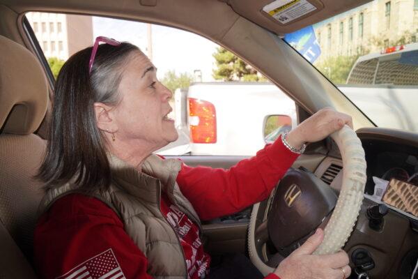 Marisa Dawson drives a car in Maricopa County, Ariz., on Nov. 18, 2022. She said she took part in the freedom convoy in Phoenix on Nov. 18 because she's "furious" at county officials' handling of the election. (Allan Stein/The Epoch Times)