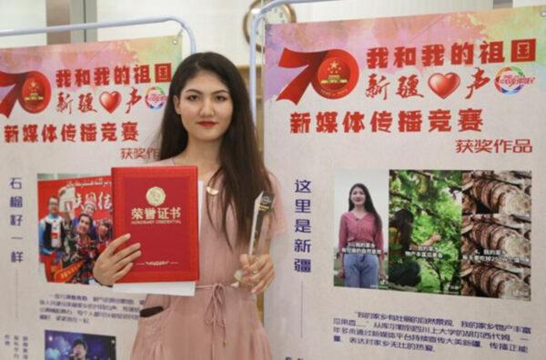 Hurshidem Ablikim being awarded at the ‘Me and my Motherland—Voice of Xinjiang’ competition. (Cyberspace Administration of China)