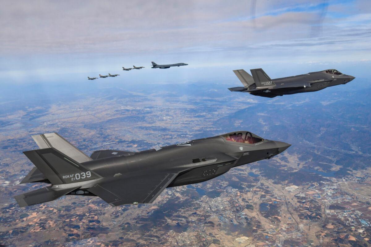 A U.S. Air Force B-1B bomber, sixth from top left, South Korean Air Force F-35 fighter jets, and U.S. Air Force F-16 fighter jets, left, fly over the South Korean Peninsula during a joint air drill in South Korea on Nov. 19, 2022. (South Korean Defense Ministry via AP)
