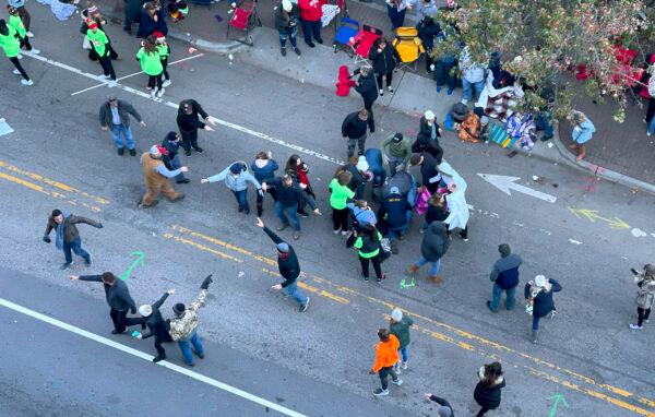 Personnel rush to where a person was injured during the Raleigh Christmas Parade on Hillsborough Street in Raleigh, N.C., on Nov. 19, 2022. (Ethan Hyman/The News & Observer via AP)