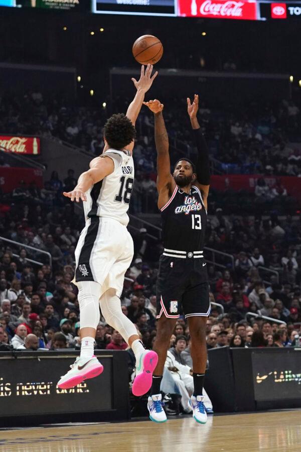 Los Angeles Clippers guard Paul George (13) shoots against San Antonio Spurs forward Isaiah Roby (18) during the first half of an NBA basketball game in Los Angeles, on Nov. 19, 2022. (Allison Dinner/AP Photo)