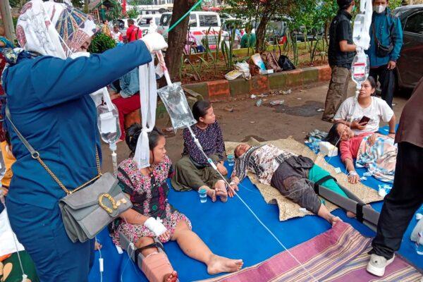 People injured during an earthquake receive medical treatment in a hospital parking lot in Cianjur, West Java, Indonesia, on Nov. 21, 2022. (Firman Taqur/AP Photo)