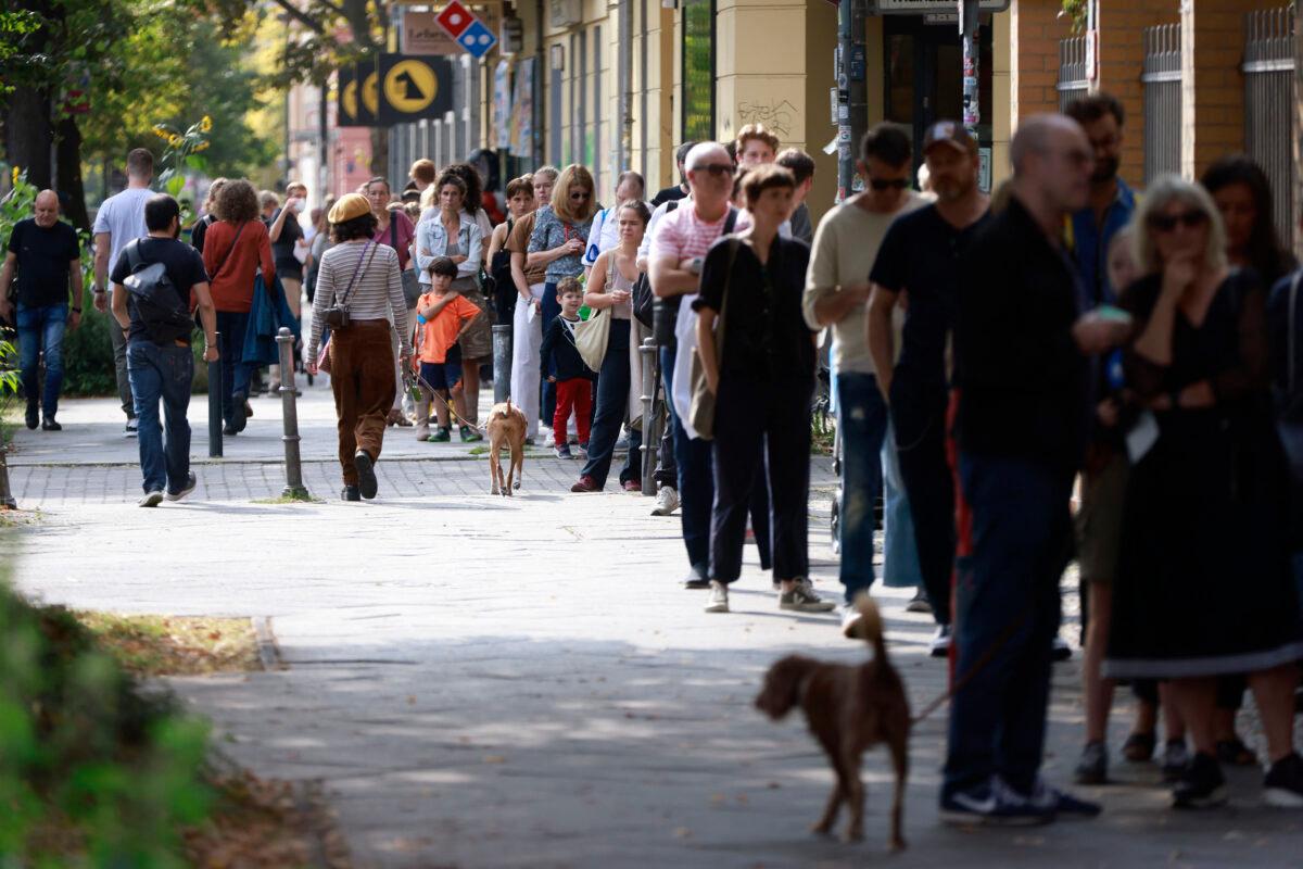 People queue outside a polling station at Volkshochschule Pankow in Berlin's Prenzlauer Allee street to cast their ballots on Sept. 26, 2021. Odd Andersen/AFP via Getty Images)