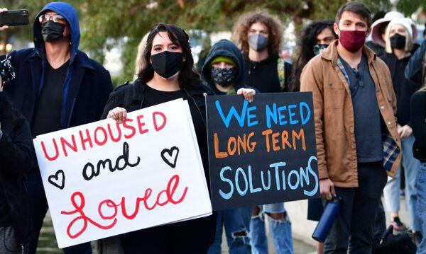 Activists, homeless residents, and supporters rally at the start of a 24-hour vigil to block a planned shutdown of a homeless encampment at Echo Lake Park in Los Angeles on March 24, 202. (Frederic J. Brown /AFP via Getty Images)