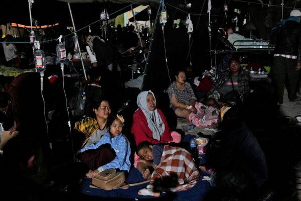 Injured survivors are being treated under a makeshift tent at a hospital in Cianjur, Indonesia, late on Nov. 21, 2022. (Tatan Syuflana/AP Photo)