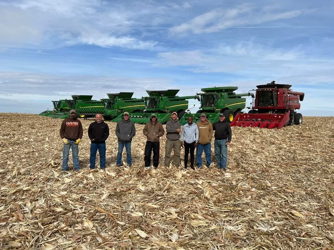 Farmers pose with combines at Paul Baker's field. (Courtesy of Melissa Baker)