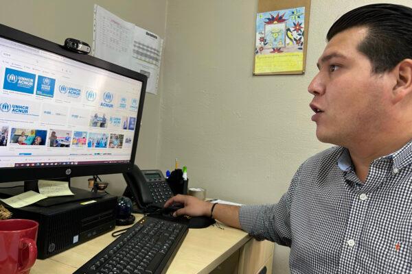 Aaron Gomez, a city official in Mexicali, Mexico, checks the U.N. website at the shelter he operates, which helps migrants obtain parole authority from the U.S. immigration system to enter the United States via a port of entry in Mexicali in November 2022. (Courtesy of Todd Bensman/Center for Immigration Studies)