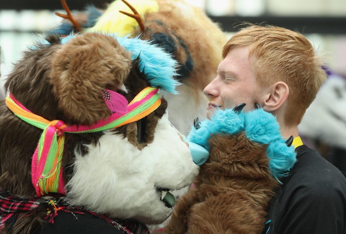 A participant not yet in his animal suit gets a furry greeting at Eurofurence in Berlin, Germany, on August 17, 2016. (Sean Gallup/Getty Images)