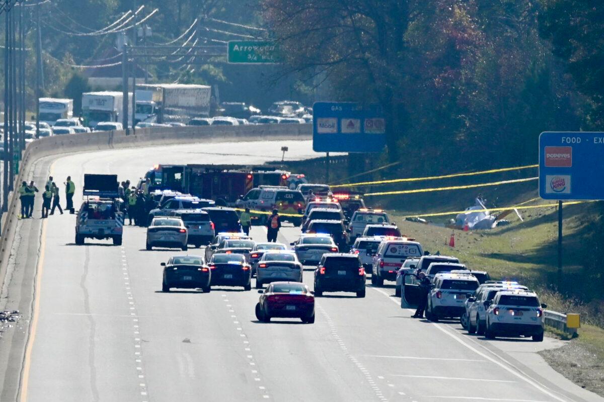 Emergency personnel work at the scene of a helicopter crash on the side of Interstate 77 South in Charlotte, N.C., on Nov. 22, 2022. (Jeff Siner/The Charlotte Observer via AP)