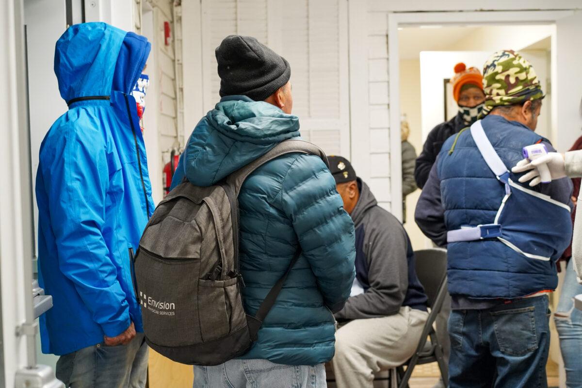 Homeless people lined up to enter Middletown Warming Station in Middletown, N.Y., on Nov. 20, 2022. (Cara Ding/The Epoch Times)