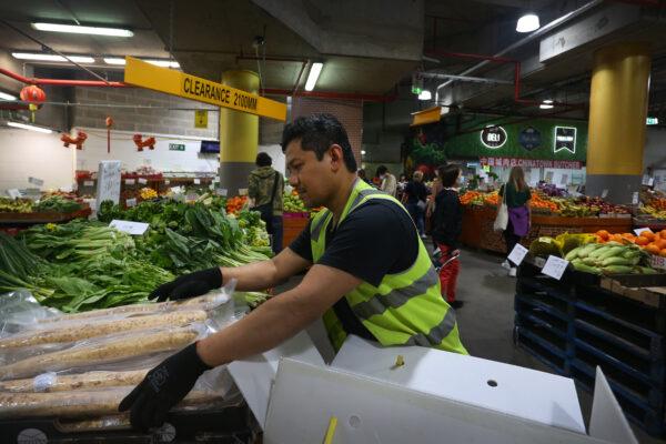 A store worker unpacks fruit and vegetable produce at Paddy's Market in Sydney, Australia, on Oct. 22, 2022. (Lisa Maree Williams/Getty Images)