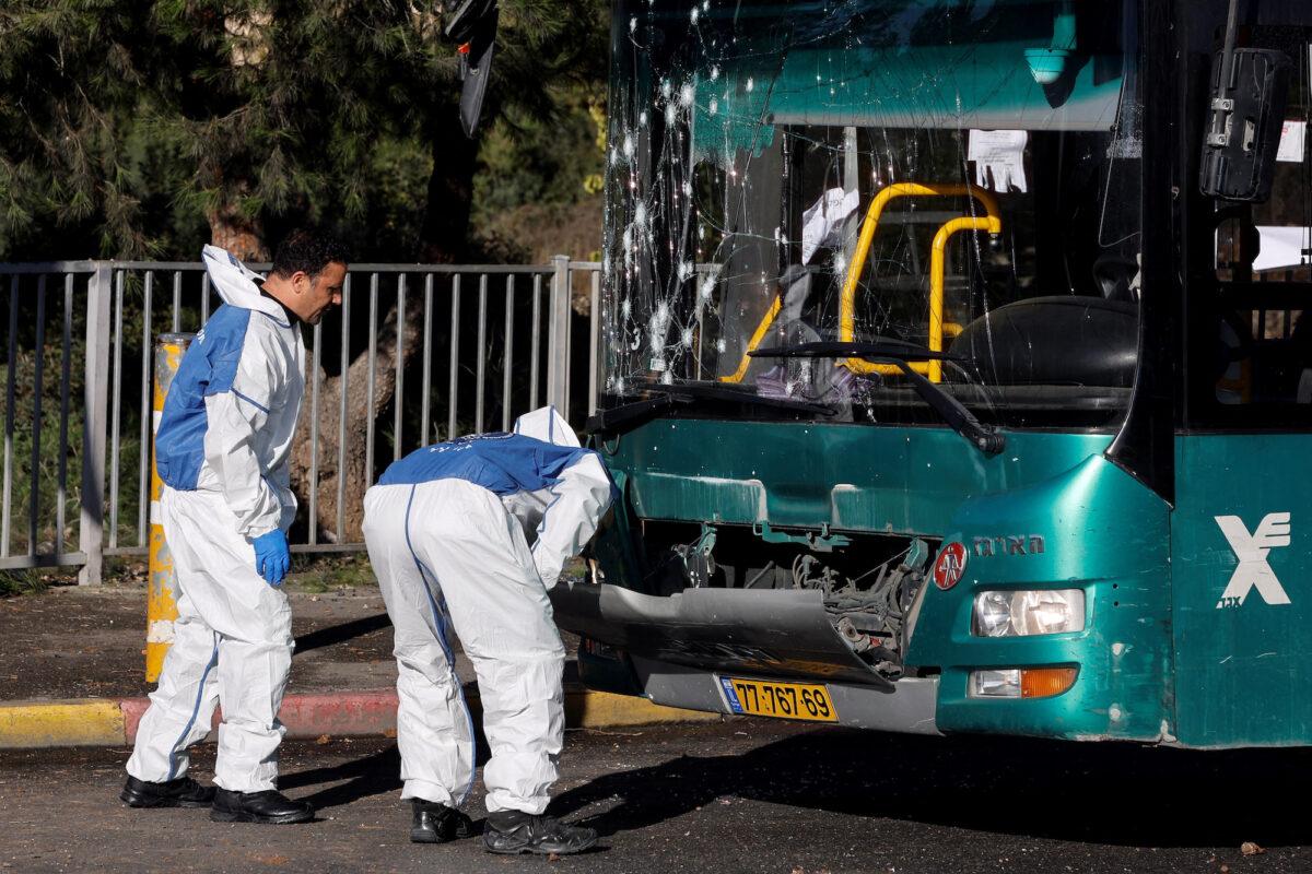 Israeli police inspect a damaged bus following an explosion at a bus stop in Jerusalem, Israel, on Nov. 23, 2022. (Ammar Awad/Reuters)