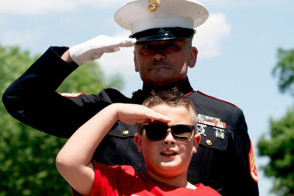 Jackson Leonard, the 8-year-old son of a U.S. Marine, salutes as motorcyclists in the Rolling to Remember ride pass near the Lincoln Memorial in Washington on May 29, 2022. (Stefani Reynolds/Getty Images)
