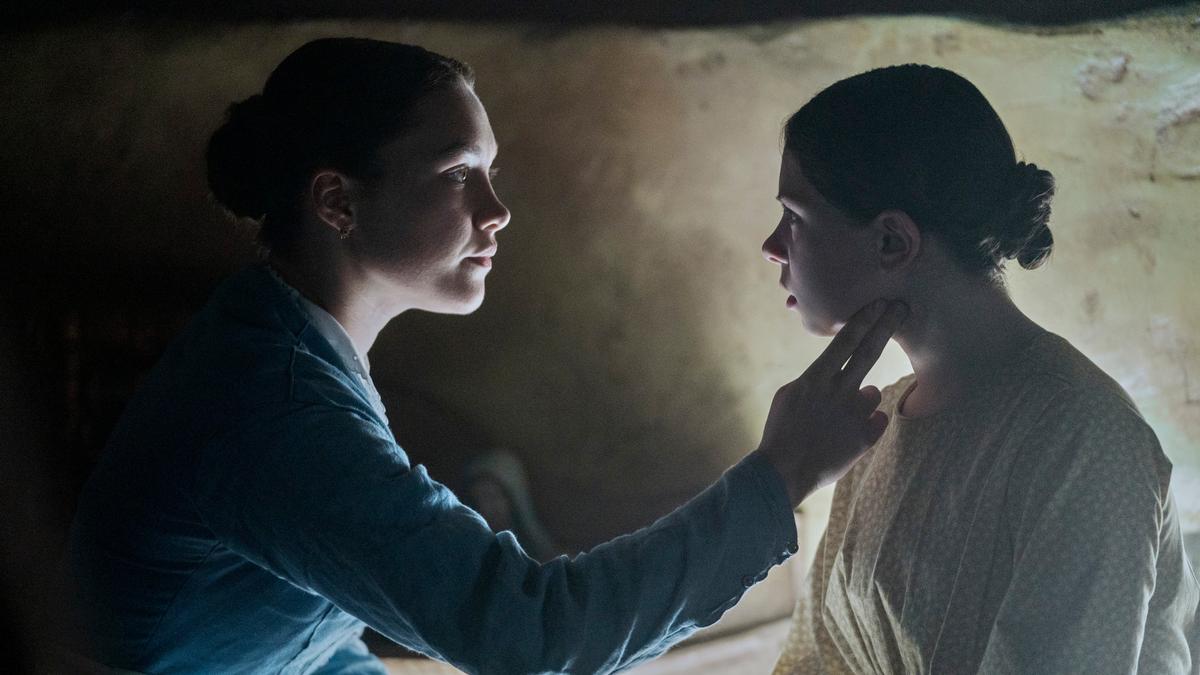 Nurse Lib Wright (Florence Pugh, L) examines miracle child Anna O'Donnell (Kila Lord Cassidy), in "The Wonder." (Element Pictures/Netflix)