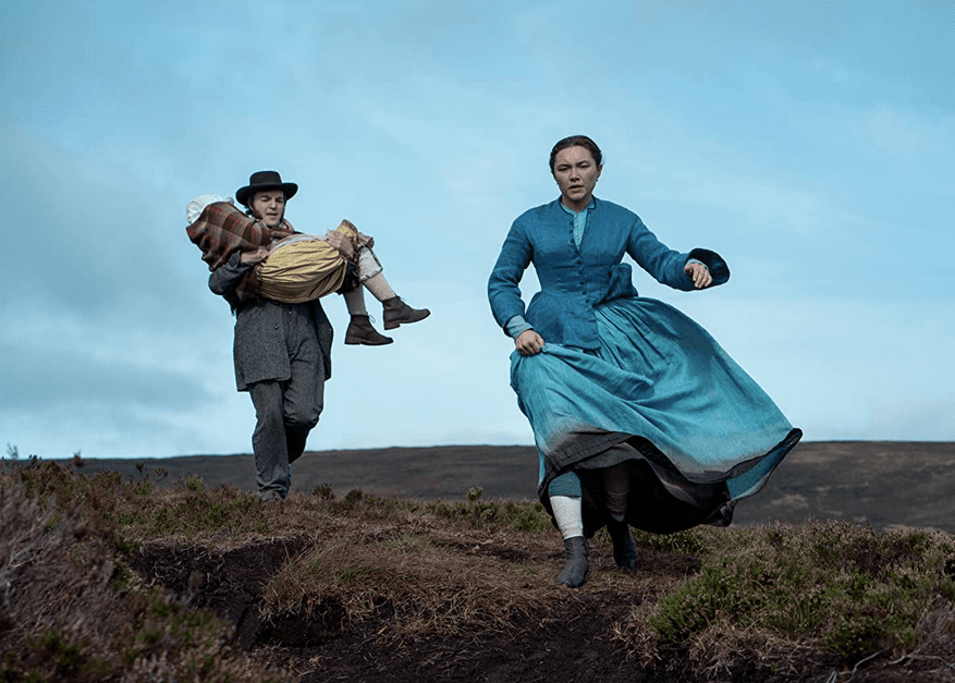 (L–R) Miracle child Anna O'Donnell (Kila Lord Cassidy), journalist Will Byrne (Tom Burke), and nurse Lib Wright (Florence Pugh). The nurse and the reporter have different plans for the child than the village elders, in "The Wonder." (Element Pictures/Netflix)