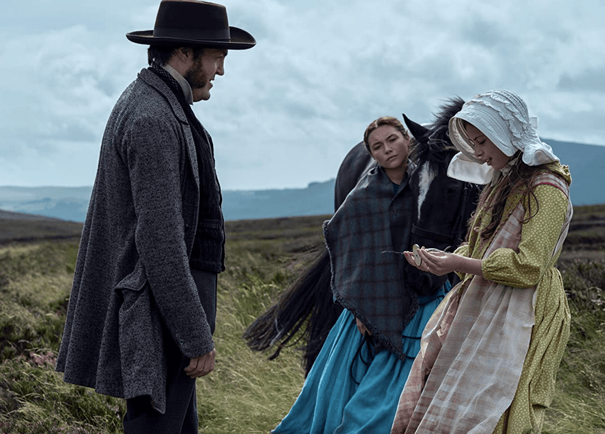 (L–R) Journalist Will Byrne (Tom Burke), nurse Lib Wright (Florence Pugh), and saintly child Anna O'Donnell (Kila Lord Cassidy) go for a walk, in "The Wonder." (Element Pictures/Netflix)