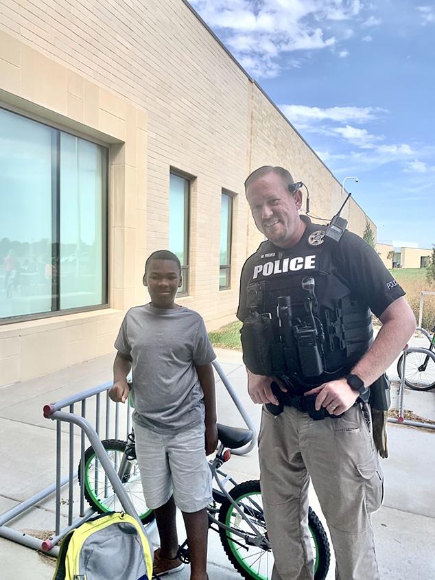 Officer Wyatt Pulver with Brandon and his brand new bike. (Courtesy of Officer Wyatt Pulver/Maize Police Department)