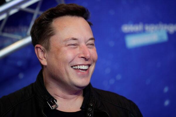 SpaceX owner and Tesla CEO Elon Musk laughs as he arrives on the red carpet for the Axel Springer Awards ceremony, in Berlin, Germany, on Dec. 1, 2020. (Hannibal Hanschke/AFP via Getty Images)