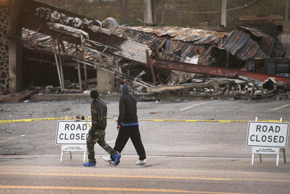 Men look over a building along West Florissant Avenue that was burned to the ground in a riot in Ferguson, Missouri, on Nov. 28, 2014. (Scott Olson/Getty Images)