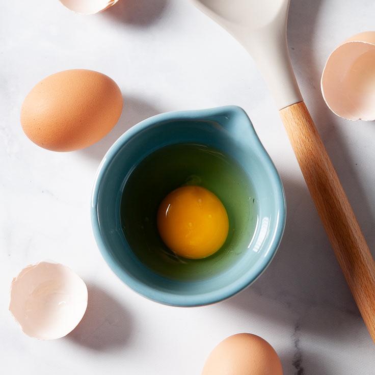 Crack each egg into a ramekin or small bowl. (Courtesy of Amy Dong)
