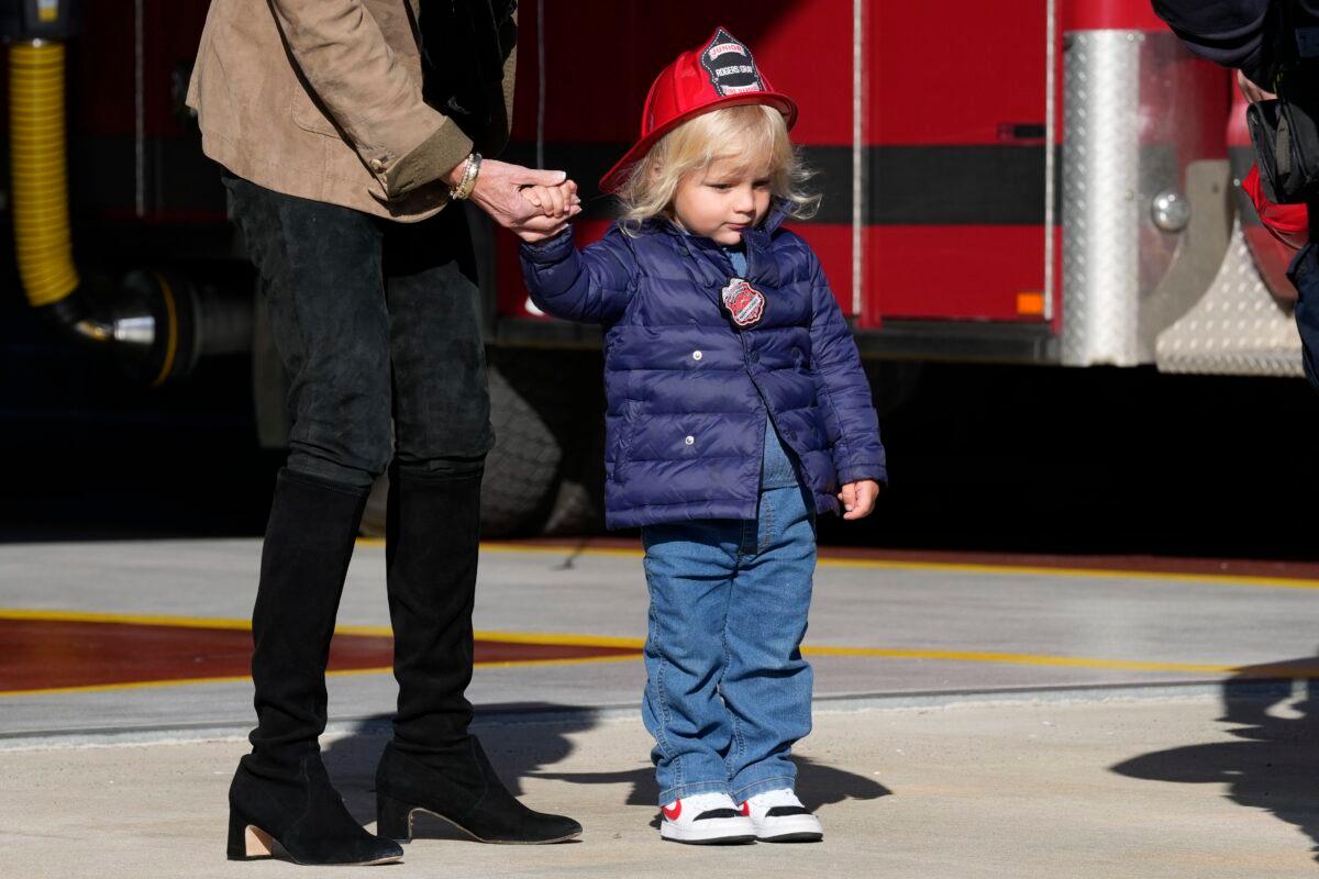 First Lady Jill Biden holds the hand of her grandson Beau Biden as they and President Joe Biden meet with firefighters on Thanksgiving Day at the Nantucket Fire Department in Nantucket, Mass., on Nov. 24, 2022. (Susan Walsh/AP Photo)
