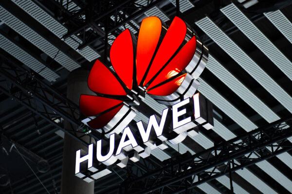 A logo sits illuminated outside the Huawei booth at the SK telecom booth on day 1 of the GSMA Mobile World Congress in Barcelona on Feb. 28, 2022. (David Ramos/Getty Images)
