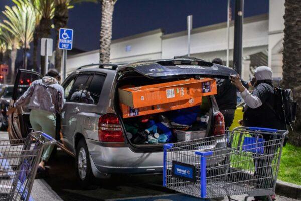 A car trunk in a Walmart parking lot is loaded with two television sets and other items following Black Friday shopping in Torrance, Calif., on Nov. 26, 2021. (Apu Gomes/AFP via Getty Images)