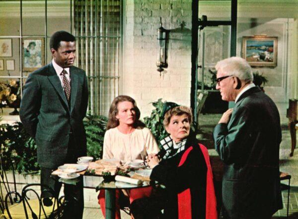 (L–R) John Prentice Jr. (Sidney Poitier) and Joanna Drayton (Kathryn Houghton) meet with her parents, Christina (Kathryn Hepburn), and Matt (Spencer Tracy) in "Guess Who's Coming to Dinner." (MovieStillsDB)