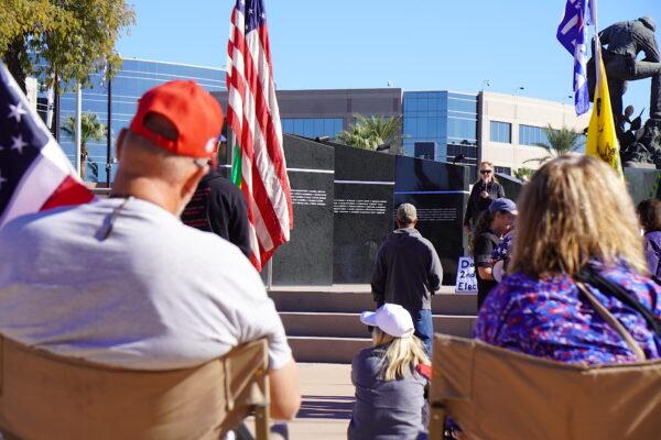 Sit-in protesters listen to a speaker at a rally to demand a new midterm election in Phoenix, Ariz., on Nov. 25, 2022. (Allan Stein/The Epoch Times)