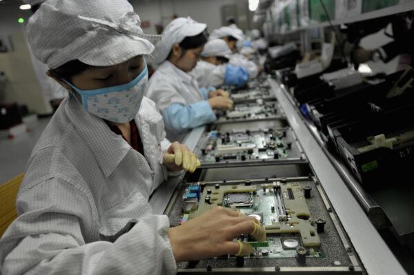 Chinese workers assemble electronic components at the Taiwanese technology giant Foxconn's factory in Shenzhen, in the southern Guangzhou province, on May 26, 2010. (AFP/AFP via Getty Images)
