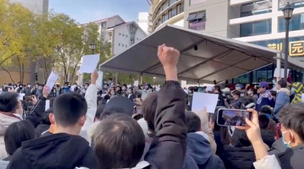 Students take part in a protest against COVID-19 curbs at Tsinghua University in Beijing, in a still from video released on Nov. 27, 2022. (Video obtained by Reuters)