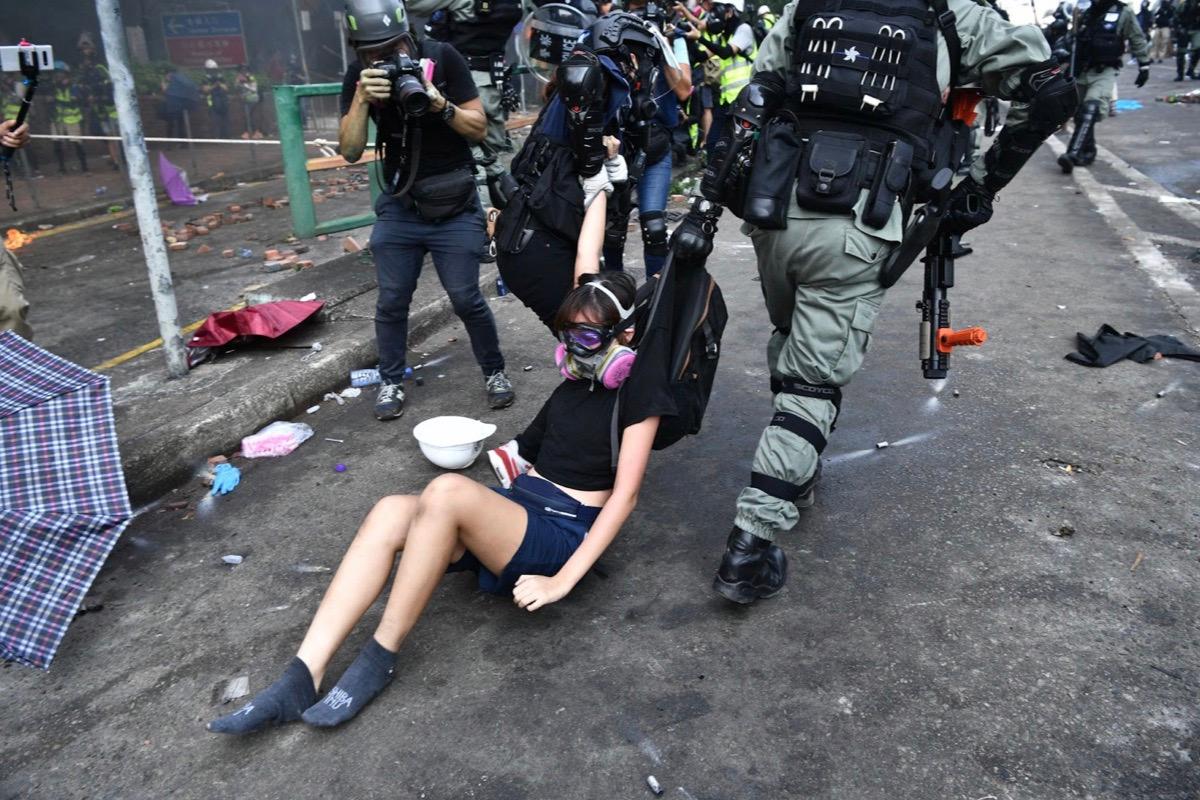 Hong Kong Police detained the protesters near the Hong Kong Polytechnic University in Hung Hom on Nov. 18, 2019. Pro-democracy protesters hid inside the campus and set the main entrance ablaze on Nov. 18 to prevent surrounding police from moving in. The police warned protesters possible use of live around. (Anthony WALLACE / AFP)