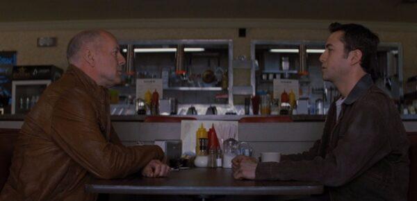 Old Joe (Bruce Willis, L) and Joe (Joseph Gordon-Levitt) meet in time at a diner in the time-travel film, "Looper." (Tri-Star Pictures)