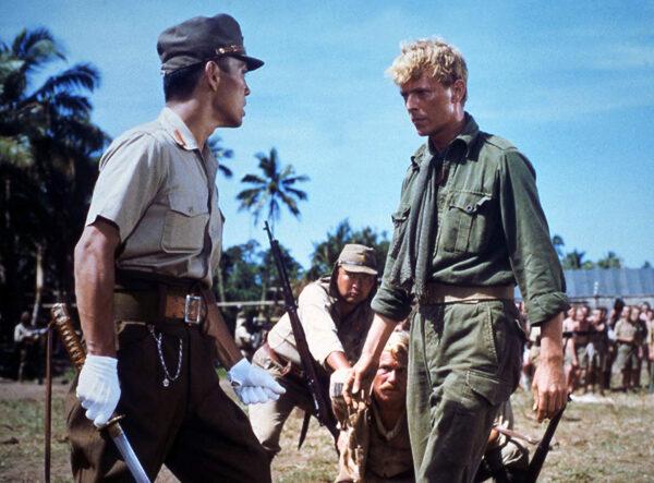 Cpt. Yonoi (Ryuichi Sakamoto, L) is confronted by Maj. Jack Celliers (David Bowie) in “Merry Christmas Mr. Lawrence” (Shochiku Fuji)