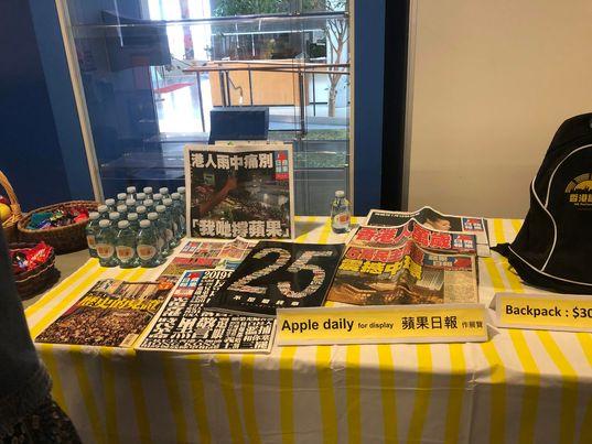 Copies of Apple Daily were sold at the screening on Nov. 26, 2022. (The Epoch Times)