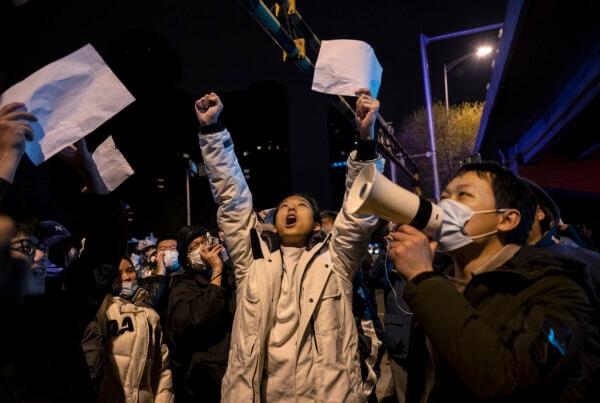 Protesters shout slogans during a protest against the Chinese Communist Party's strict zero COVID measures in Beijing, China, on Nov. 28, 2022. (Kevin Frayer/Getty Images)