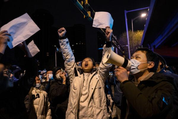 Protesters shout slogans during a protest against China's strict zero-COVID measures in Beijing on Nov. 28, 2022. (Kevin Frayer/Getty Images)