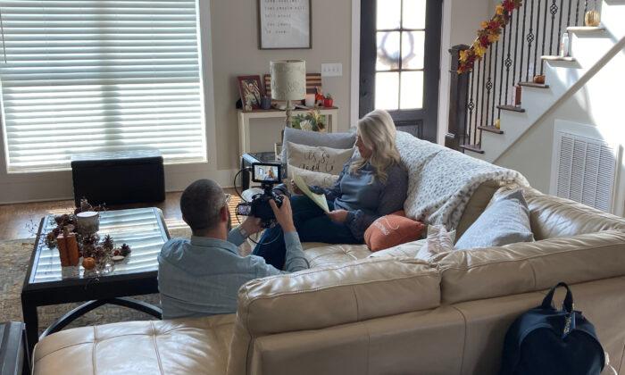 Videographer Tal Atzmon films Sarah McAbee reading a letter penned by her husband, Jan. 6 detainee Ronald McAbee, whose case will be featured in a forthcoming documentary from The Epoch Times. (Joseph Hanneman/The Epoch Times)