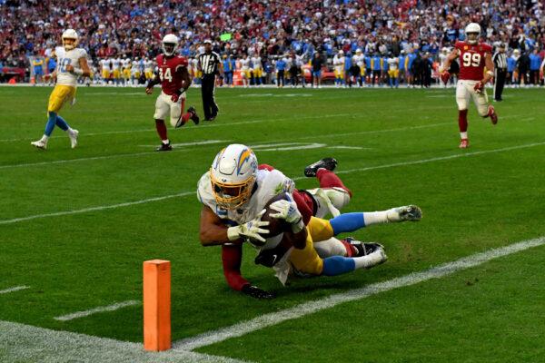 Austin Ekeler (30) of the Los Angeles Chargers scores on a rushing touchdown in the fourth quarter of a game against the Arizona Cardinals at State Farm Stadium in Glendale, Ariz., on Nov. 27, 2022. (Norm Hall/Getty Images)